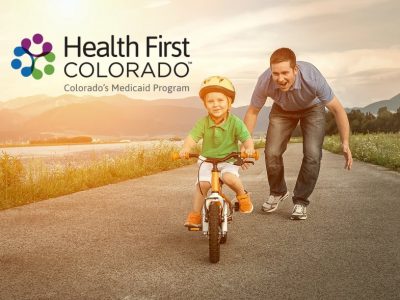 Health First Colorado - boy father bike with logo